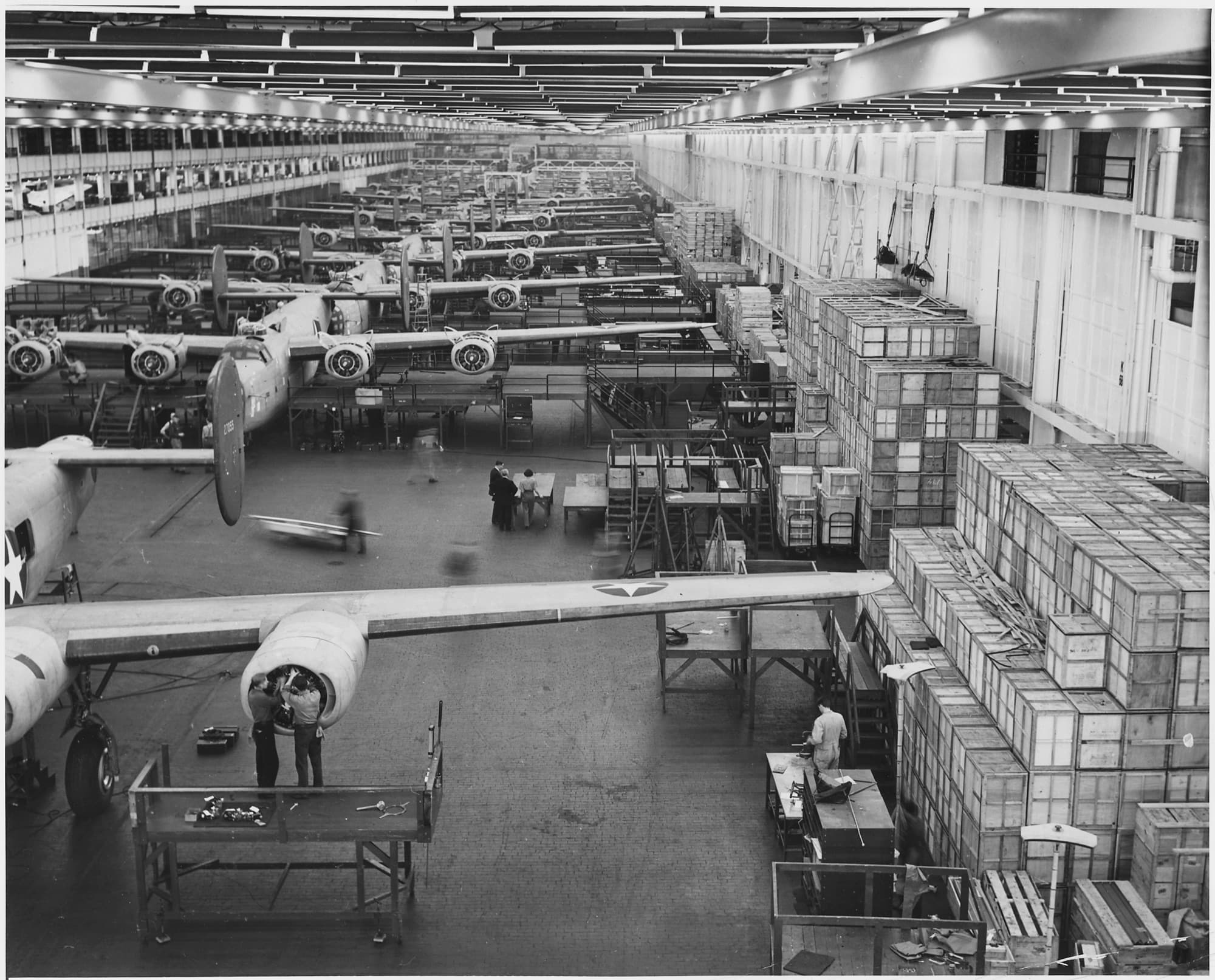The B-24 bomber assembly line at Ford's Willow Run plant in 1943, aircraft in rows under factory lights